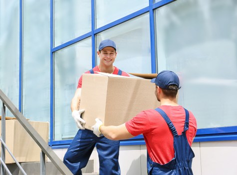 Man with van loading moving boxes into a vehicle