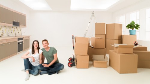 Professional movers handling household items in a Finchley home