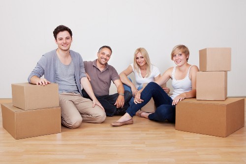 Local moving team carrying furniture in Finchley